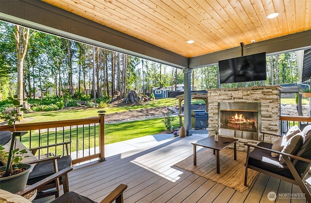 13426 108th St NE, Lake Stevens, WA 98258 - deck with an outdoor stone fireplace and a lawn
