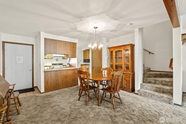 110 Icicle Unit K, Leavenworth, WA 98826 - dining room with stairs, a chandelier, and light carpet