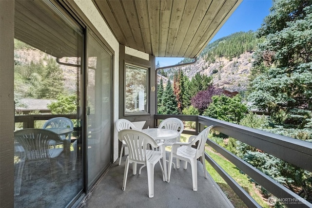 110 Icicle Unit K, Leavenworth, WA 98826 - balcony featuring outdoor dining space, a mountain view, and a wooded view