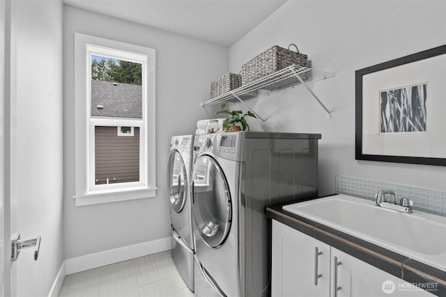 9909 123rd Ln NE, Kirkland, WA 98033 - washroom with washing machine and clothes dryer and baseboards