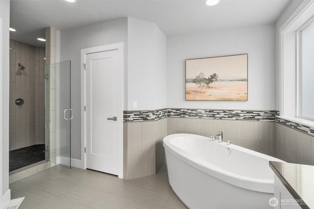 9909 123rd Ln NE, Kirkland, WA 98033 - full bathroom with a stall shower, a freestanding bath, recessed lighting, tile patterned floors, and a wainscoted wall