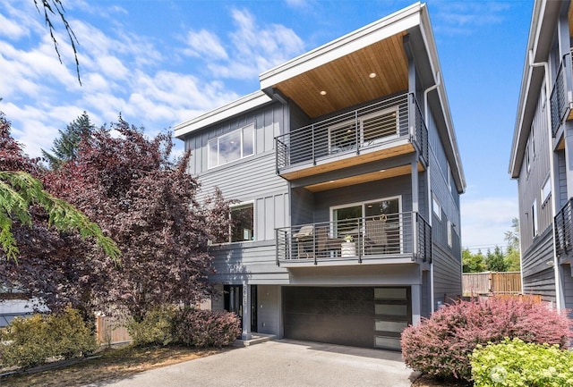 9909 123rd Ln NE, Kirkland, WA 98033 - back of property with a balcony, a garage, and driveway