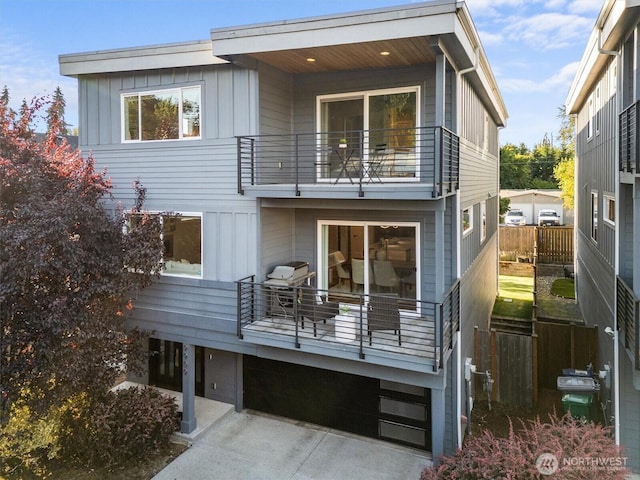 9909 123rd Ln NE, Kirkland, WA 98033 - rear view of property featuring a balcony and board and batten siding
