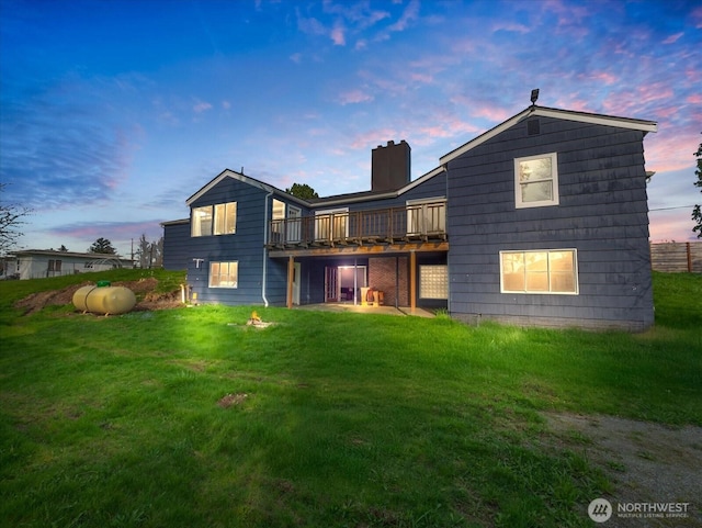 5041 Guide Meridian, Bellingham, WA 98226 - back of property at dusk featuring a wooden deck, a lawn, and a chimney