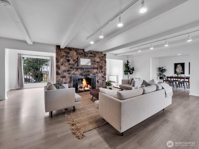 5041 Guide Meridian, Bellingham, WA 98226 - living room with rail lighting, beam ceiling, wood finished floors, and a fireplace