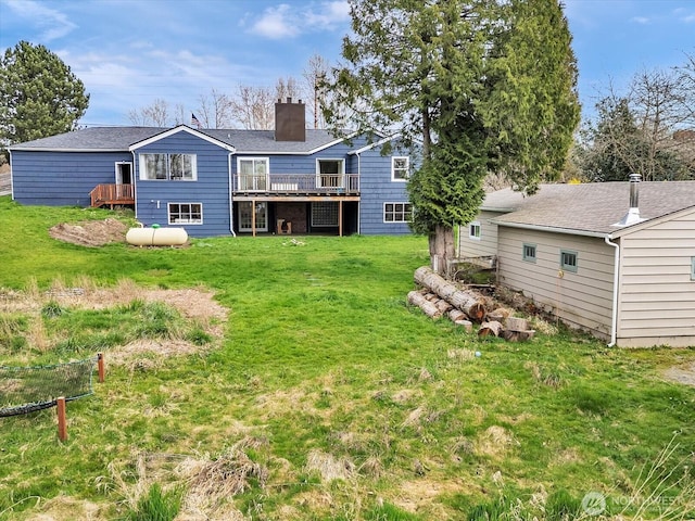 5041 Guide Meridian, Bellingham, WA 98226 - rear view of property featuring a chimney, a wooden deck, and a lawn