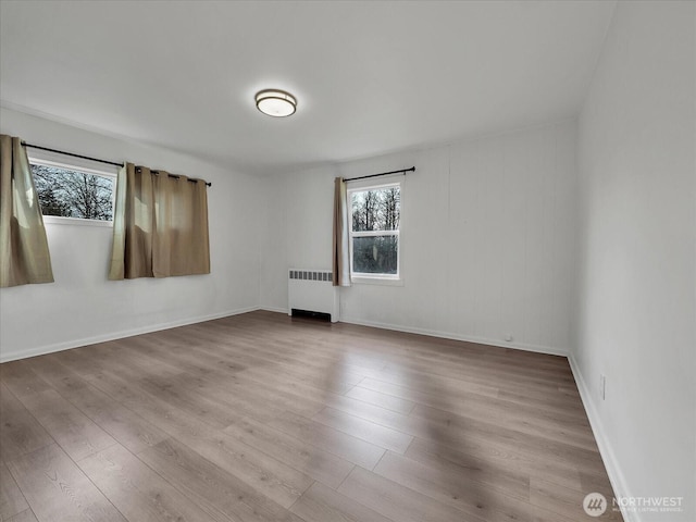 5041 Guide Meridian, Bellingham, WA 98226 - empty room featuring radiator, plenty of natural light, and wood finished floors