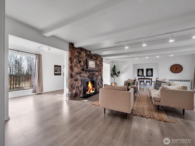 5041 Guide Meridian, Bellingham, WA 98226 - living area with radiator, wood finished floors, a fireplace, and beamed ceiling