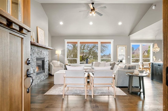 1312 Bradley Meadows Ct, Lynden, WA 98263 - living room with a stone fireplace, plenty of natural light, dark wood-style flooring, high vaulted ceiling, and ceiling fan