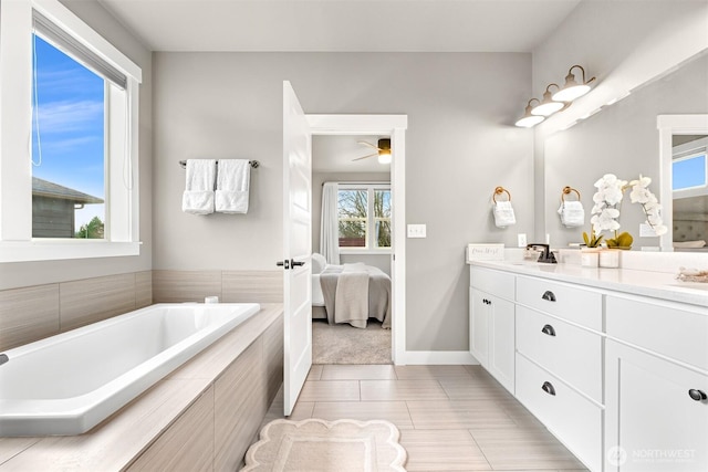 1312 Bradley Meadows Ct, Lynden, WA 98263 - bathroom featuring double vanity, ensuite bathroom, a bath, ceiling fan, and tile patterned floors
