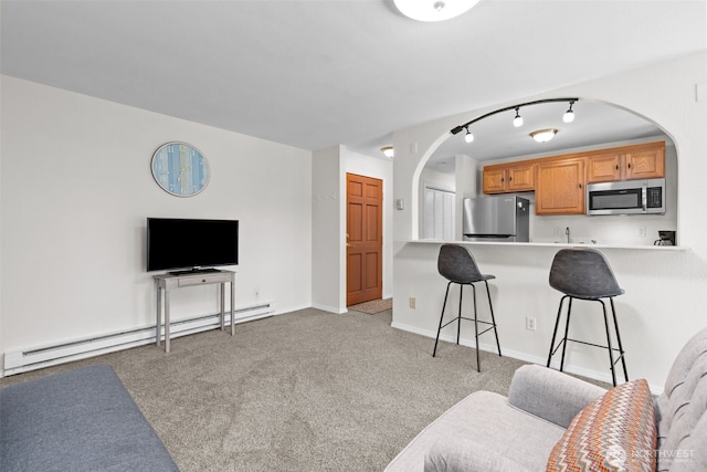 15152 65th Ave S Unit 818, Tukwila, WA 98188 - carpeted living room with a baseboard radiator and arched walkways