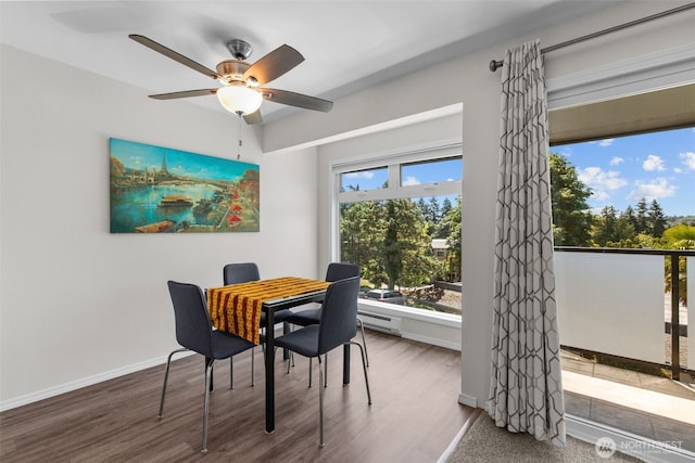 15152 65th Ave S Unit 818, Tukwila, WA 98188 - dining room featuring ceiling fan, wood finished floors, and baseboard heating