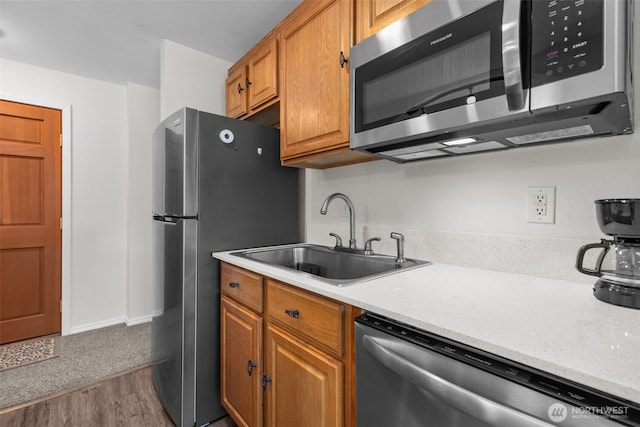 15152 65th Ave S Unit 818, Tukwila, WA 98188 - kitchen featuring stainless steel appliances, light countertops, wood finished floors, and brown cabinets