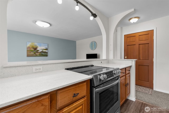 15152 65th Ave S Unit 818, Tukwila, WA 98188 - kitchen featuring stainless steel electric stove and brown cabinetry
