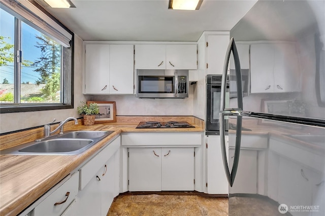 4239 S 184th Pl, Seatac, WA 98188 - kitchen with black appliances, white cabinets, and light countertops