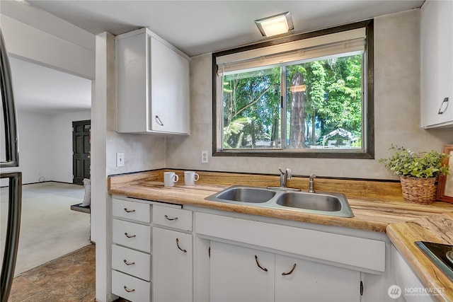 4239 S 184th Pl, Seatac, WA 98188 - kitchen with light countertops, white cabinets, and black electric cooktop