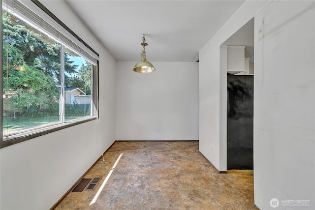 4239 S 184th Pl, Seatac, WA 98188 - unfurnished dining area with stone finish flooring and baseboards