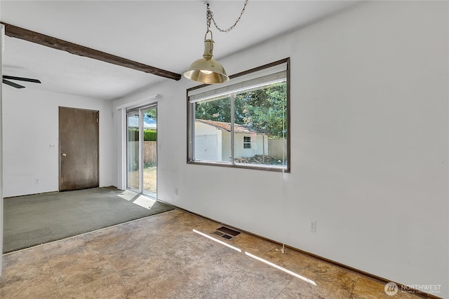 4239 S 184th Pl, Seatac, WA 98188 - unfurnished dining area with stone finish floors, beamed ceiling, ceiling fan, and carpet