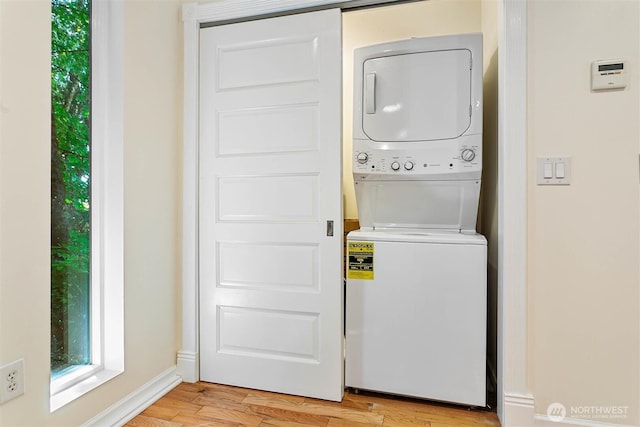3915 Gilmore Rd, Everson, WA 98247 - washroom featuring stacked washer / drying machine, plenty of natural light, and light wood-type flooring