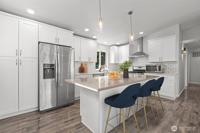 1713 S 30th St, Mount Vernon, WA 98274 - kitchen with stainless steel appliances, wall chimney exhaust hood, decorative backsplash, dark wood-type flooring, and recessed lighting