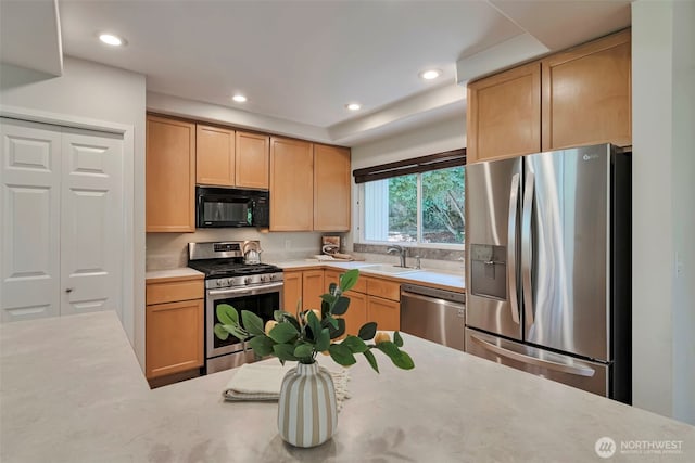 14627 SE Newport Way, Bellevue, WA 98006 - kitchen featuring appliances with stainless steel finishes, light countertops, light brown cabinets, and recessed lighting