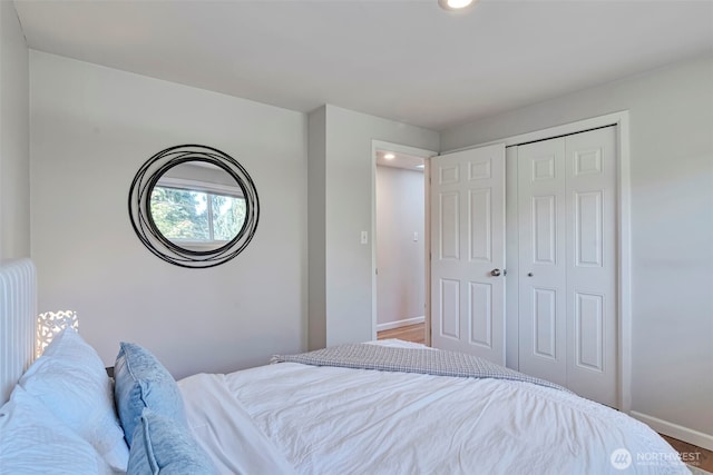 14627 SE Newport Way, Bellevue, WA 98006 - bedroom featuring a closet, recessed lighting, radiator heating unit, and wood finished floors