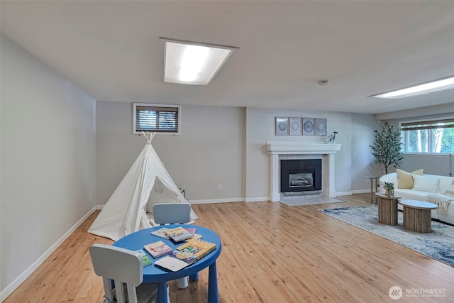 14627 SE Newport Way, Bellevue, WA 98006 - recreation room featuring light wood-type flooring and a tiled fireplace