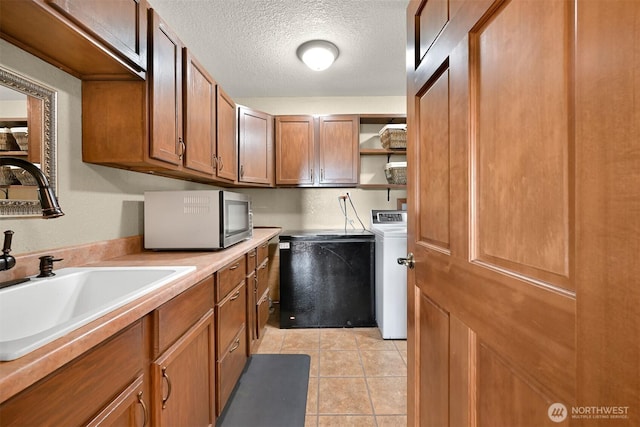 4054 Cabrant Rd, Everson, WA 98247 - laundry room featuring washer / dryer, a textured ceiling, and light tile patterned flooring
