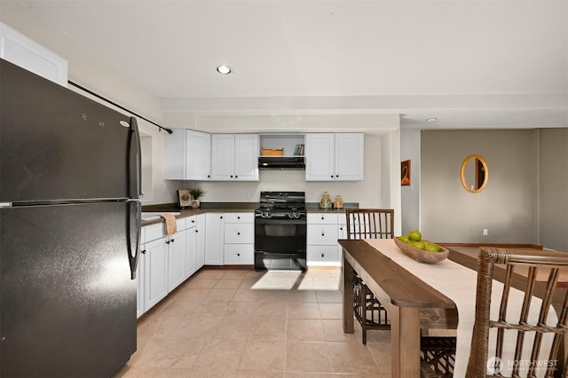 4054 Cabrant Rd, Everson, WA 98247 - kitchen featuring black appliances, under cabinet range hood, dark countertops, light tile patterned flooring, and white cabinetry
