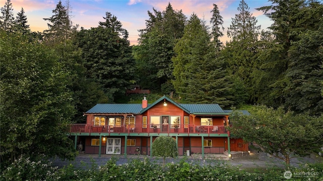4054 Cabrant Rd, Everson, WA 98247 - back of property with french doors, a metal roof, a wooden deck, and a chimney