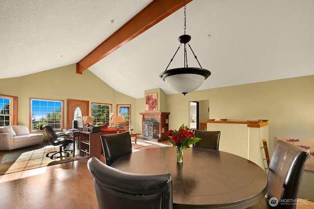 4054 Cabrant Rd, Everson, WA 98247 - dining area featuring beam ceiling, high vaulted ceiling, wood finished floors, and a fireplace