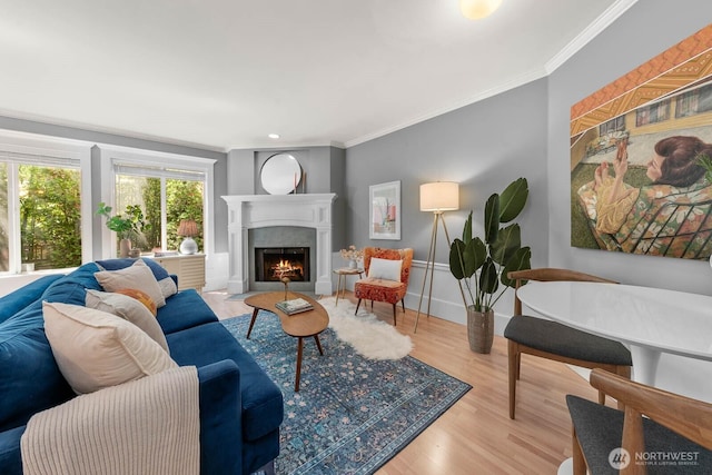 727 N 85th St Unit 102, Seattle, WA 98103 - living area featuring ornamental molding, a fireplace with flush hearth, and wood finished floors