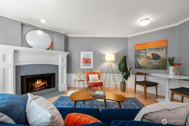 727 N 85th St Unit 102, Seattle, WA 98103 - living area featuring crown molding, a fireplace with flush hearth, wood finished floors, and recessed lighting