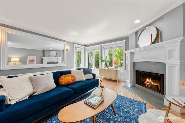 727 N 85th St Unit 102, Seattle, WA 98103 - living area with ornamental molding, a tiled fireplace, wood finished floors, and recessed lighting