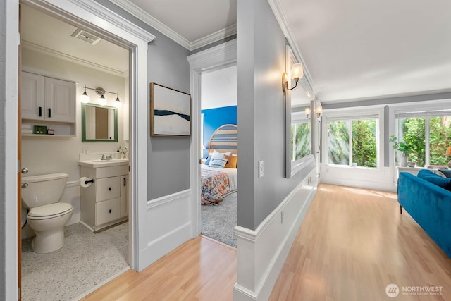 727 N 85th St Unit 102, Seattle, WA 98103 - hallway with light wood-style floors and crown molding