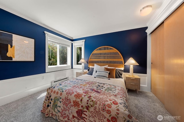 727 N 85th St Unit 102, Seattle, WA 98103 - carpeted bedroom featuring crown molding, a baseboard radiator, and a wainscoted wall