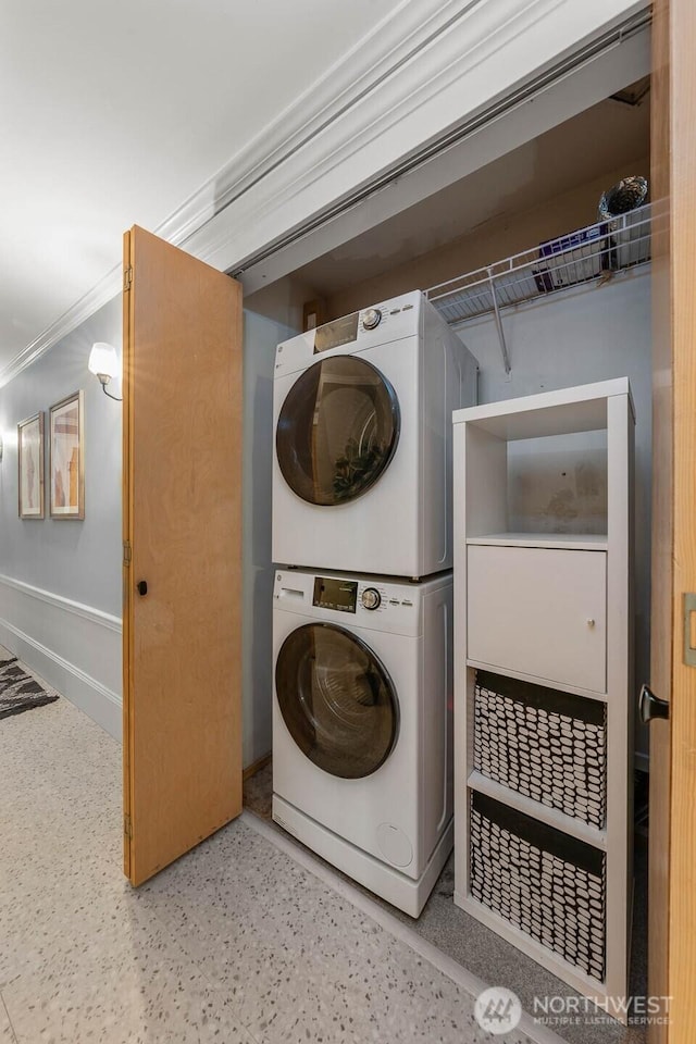 727 N 85th St Unit 102, Seattle, WA 98103 - laundry area with stacked washing machine and dryer and crown molding