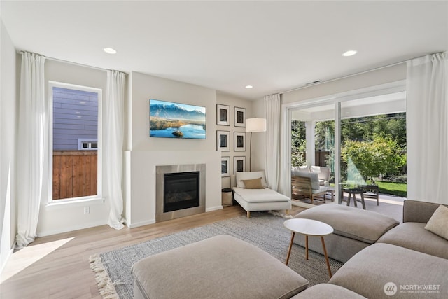 16204 27th Street Ct E, Lake Tapps, WA 98391 - living room featuring light wood finished floors, a glass covered fireplace, and recessed lighting