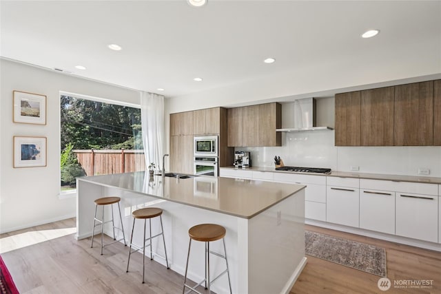 16204 27th Street Ct E, Lake Tapps, WA 98391 - kitchen featuring wall chimney range hood, stainless steel appliances, modern cabinets, a breakfast bar area, and recessed lighting
