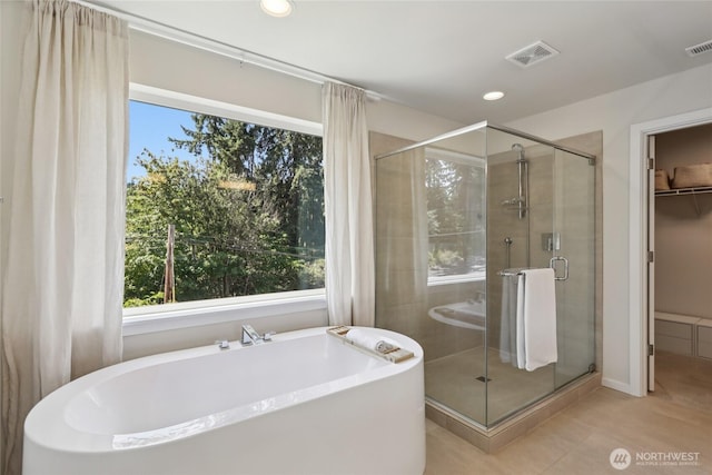 16204 27th Street Ct E, Lake Tapps, WA 98391 - bathroom featuring a freestanding bath, tile patterned flooring, a shower stall, recessed lighting, and a walk in closet