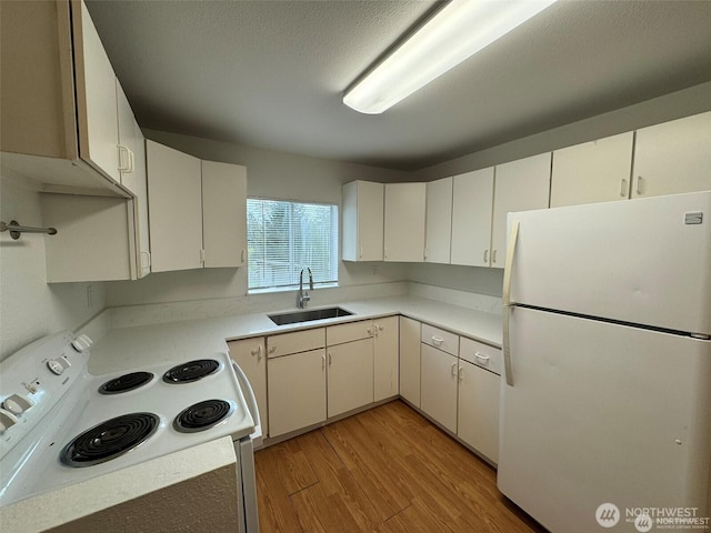 16425 Broadway Ave, Snohomish, WA 98296 - kitchen featuring white appliances, light wood-style floors, light countertops, and white cabinets