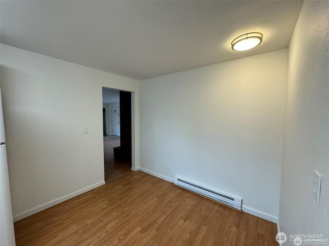 16425 Broadway Ave, Snohomish, WA 98296 - unfurnished room with baseboard heating and wood finished floors