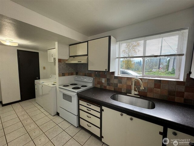 16425 Broadway Ave, Snohomish, WA 98296 - kitchen with white range with electric cooktop, washing machine and clothes dryer, under cabinet range hood, white cabinets, and backsplash