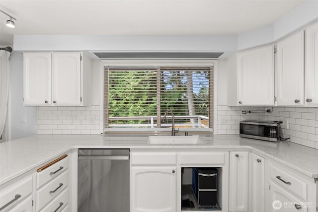 3527 Cain Rd SE, Olympia, WA 98501 - kitchen with appliances with stainless steel finishes, white cabinetry, decorative backsplash, and light stone countertops