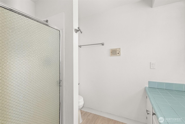 3527 Cain Rd SE, Olympia, WA 98501 - full bathroom with a stall shower, wood finished floors, and vanity