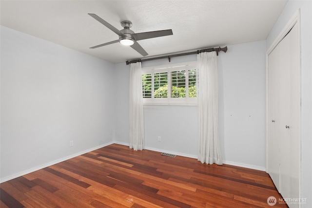 3527 Cain Rd SE, Olympia, WA 98501 - unfurnished bedroom featuring wood finished floors, a closet, and a ceiling fan