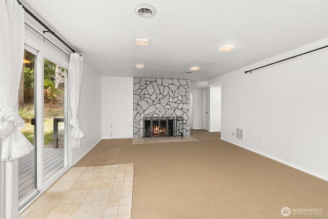 3527 Cain Rd SE, Olympia, WA 98501 - unfurnished living room featuring a stone fireplace and carpet