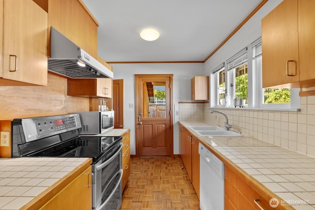 3522 S Leschi Pl, Seattle, WA 98144 - kitchen featuring appliances with stainless steel finishes, exhaust hood, tile countertops, ornamental molding, and backsplash