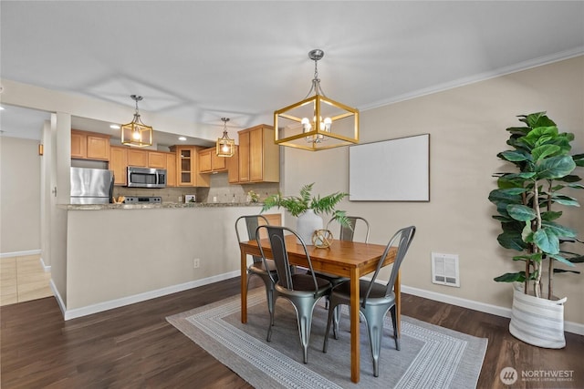 1302 N 6th St Unit 8, Tacoma, WA 98403 - dining area with dark wood-type flooring, a chandelier, recessed lighting, and crown molding