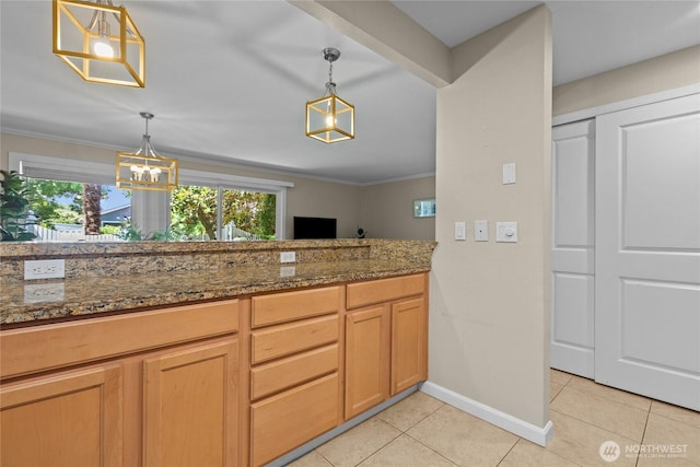 1302 N 6th St Unit 8, Tacoma, WA 98403 - kitchen with light tile patterned floors, healthy amount of natural light, decorative light fixtures, dark stone countertops, and crown molding